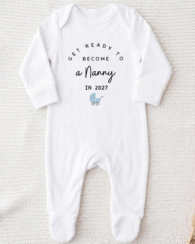 A white bodysuit with text and a small baby carriage graphic on it.