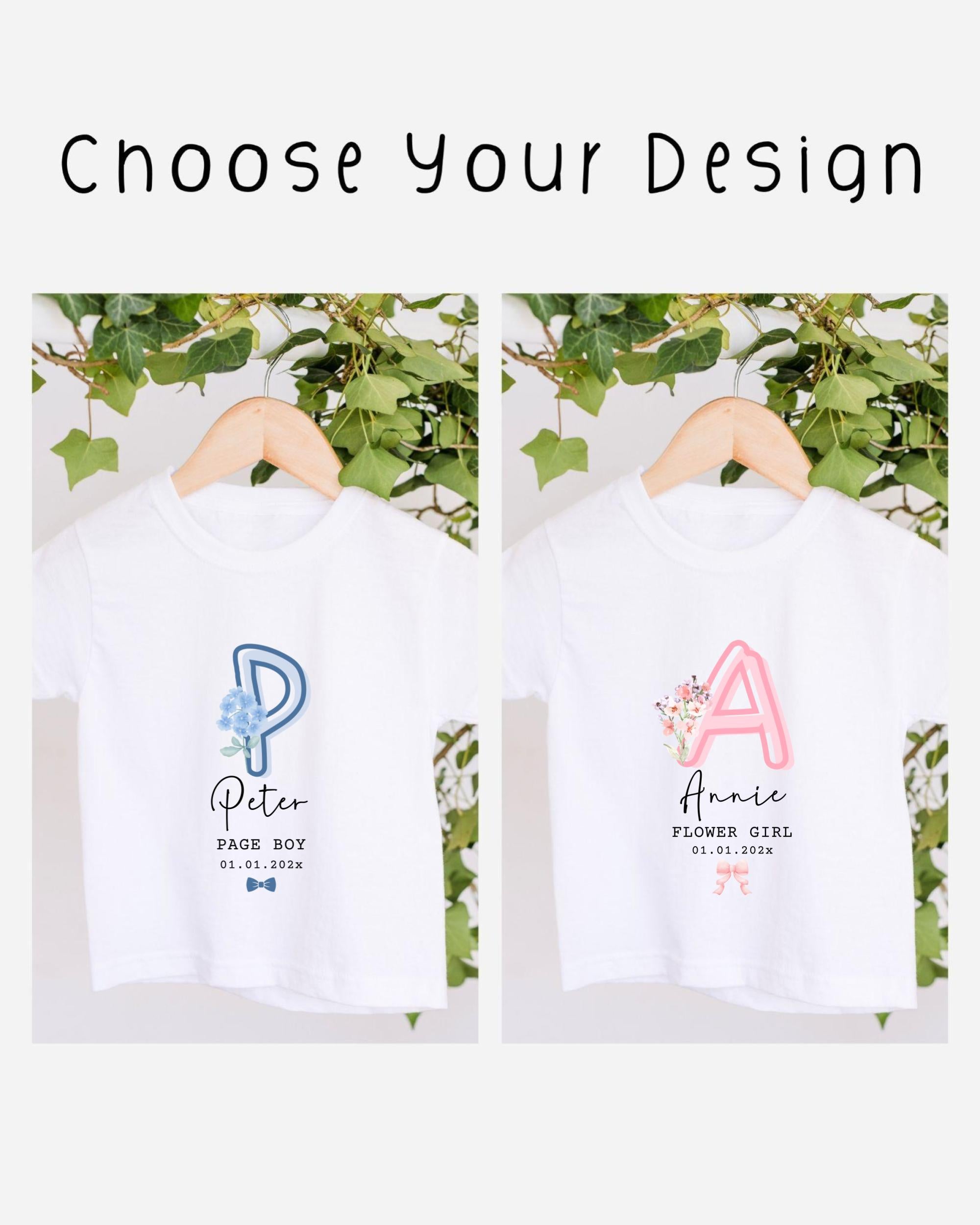 two white t-shirts with personalized text and names printed on them, hanging on a wooden hanger.