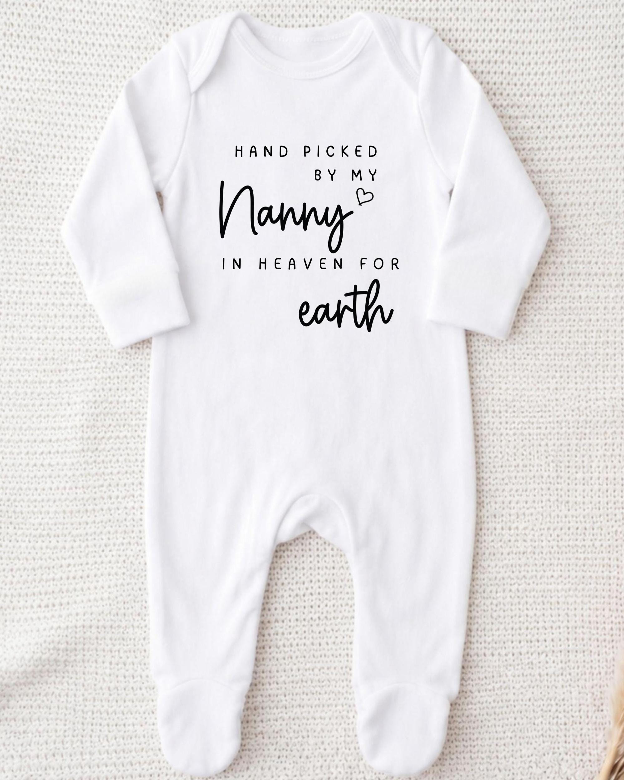 A white onesie with black text that reads "Hand picked by my Nanny in heaven for earth".