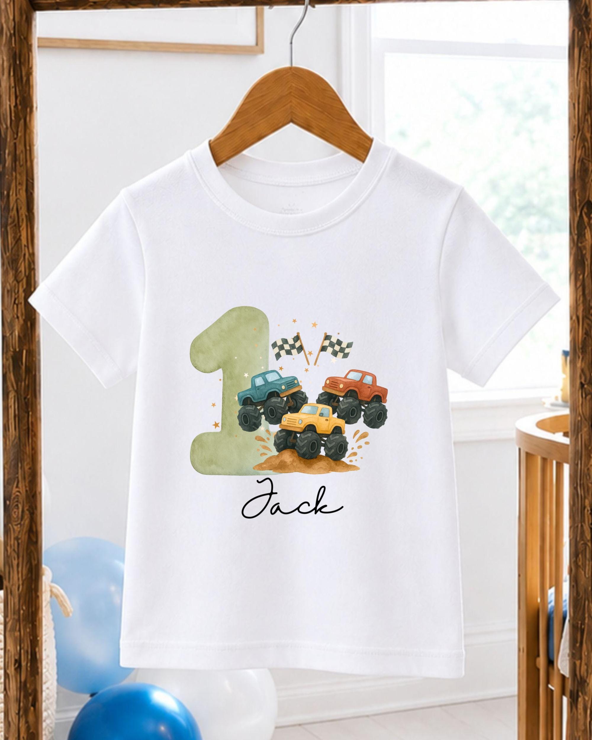 A white t-shirt with a graphic design featuring a green truck and two other trucks, along with a number 1 and a flag.