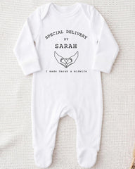 A white onesie with text and a graphic design on it.