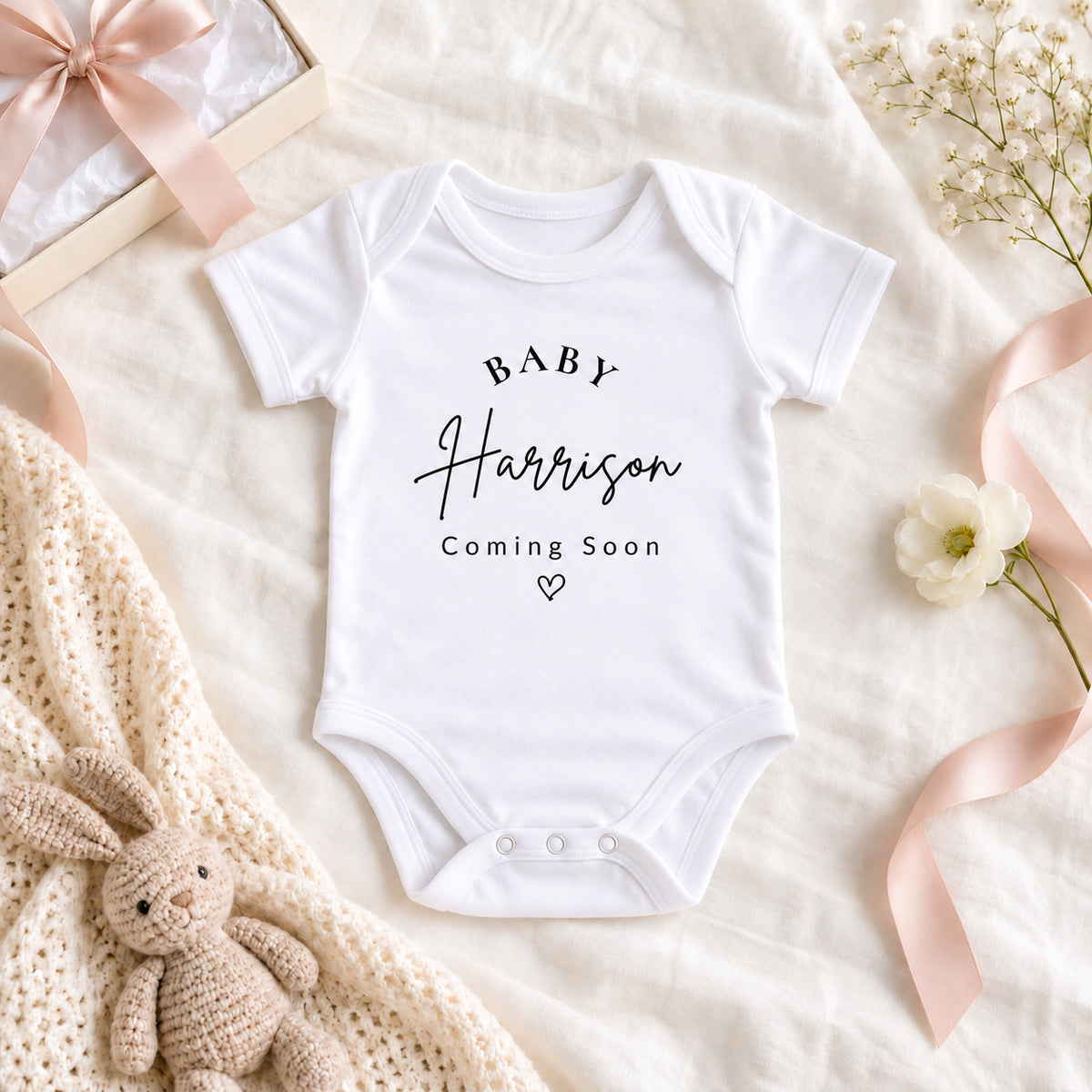 Personalised Baby Harrison Coming Soon pregnancy announcement vest, presented with a pink ribbon and knitted bunny