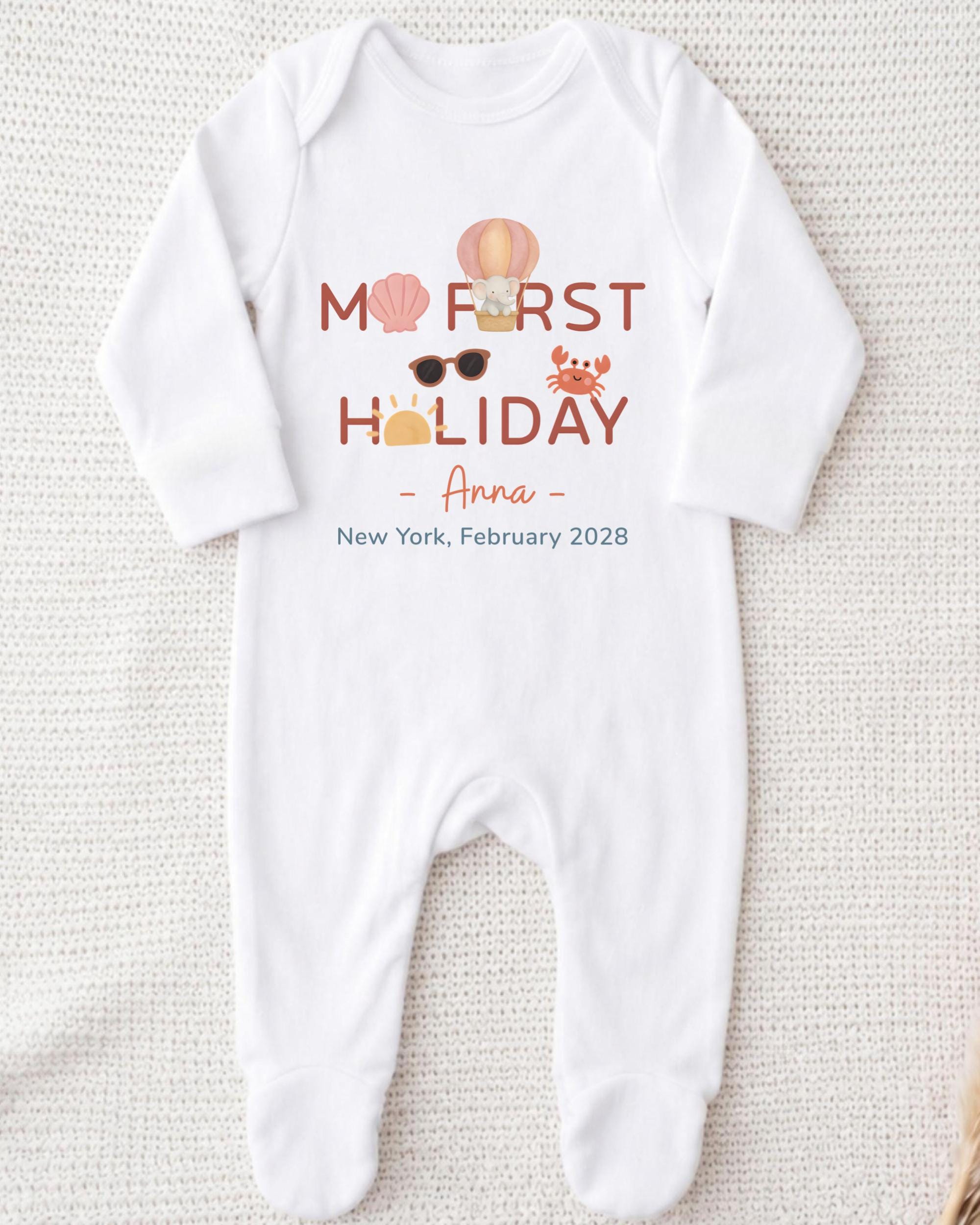 A white onesie with text and illustrations on it, laid out on a white background.