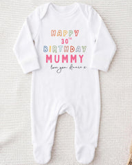 A white onesie with text printed on it, likely a birthday outfit for a baby.
