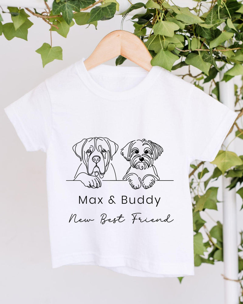 A white t-shirt with a graphic design of two dogs, one larger and one smaller, sitting together and the text "Max & Buddy New Best Friend" below the image.