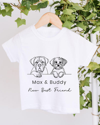 A white t-shirt with a graphic design of two dogs, one larger and one smaller, sitting together and the text "Max & Buddy New Best Friend" below the image.