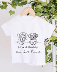 A white t-shirt with a graphic design of two dogs, one larger and one smaller, sitting together and the text "Max & Buddy New Best Friend" below the image.