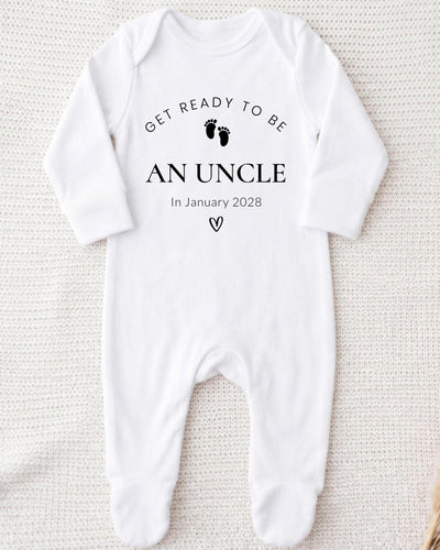 A white bodysuit with the text "Get ready to be an uncle In January 2028" printed on it.