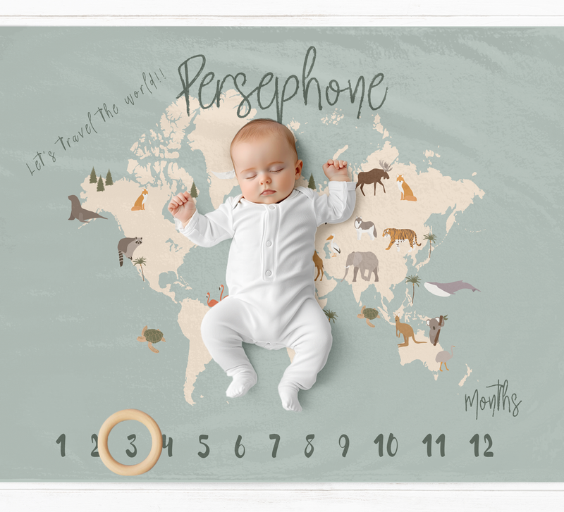a baby is laying on a map of the world