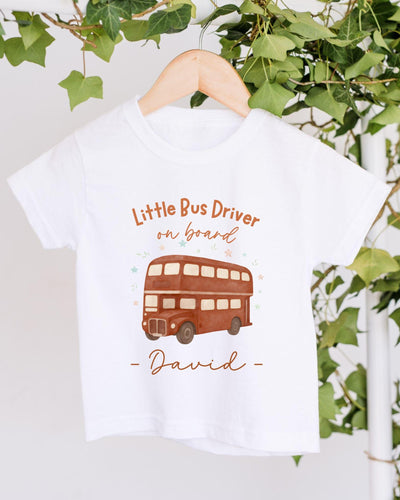 A white t-shirt with a printed design of a double-decker bus and the text "Little Bus Driver on board David" printed on it.