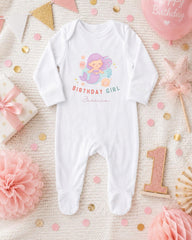 A white onesie with a mermaid design and the text "BIRTHDAY GIRL Jessica" printed on it, along with a "1" birthday number and pink and gold decorations.