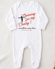 A white onesie with a graphic design and text printed on it.