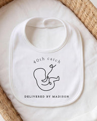 A white bib with a black graphic design and text printed on it.