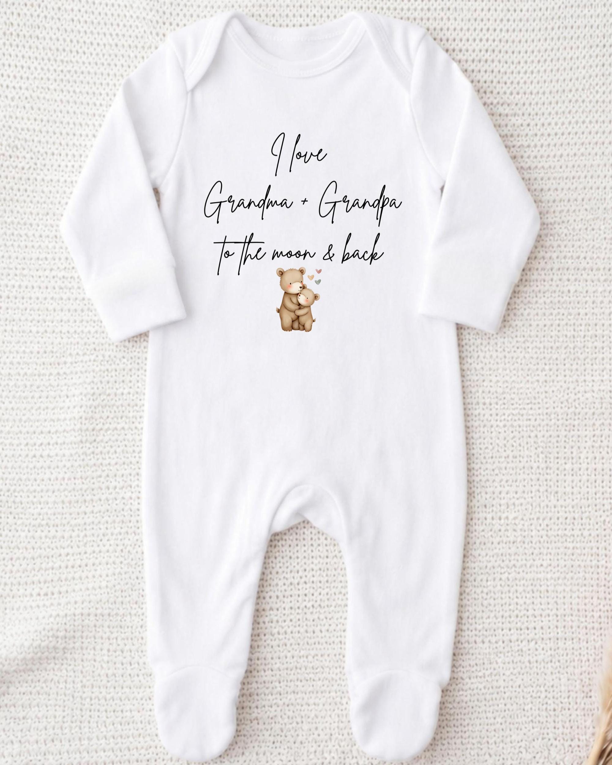 A white onesie with text and an illustration of a teddy bear.
