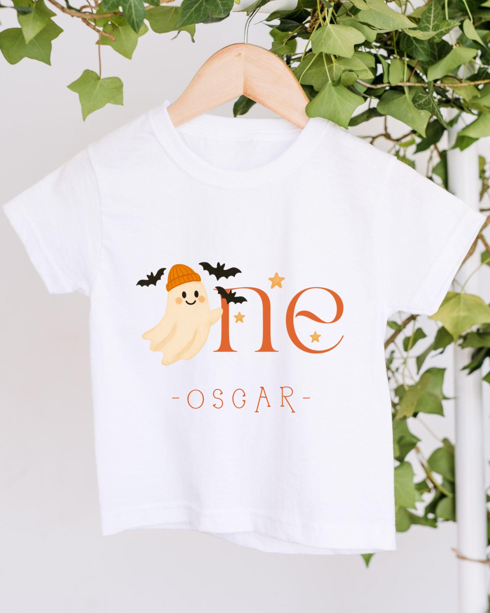 A white t-shirt with a graphic design featuring a ghost character and the text "One Oscar" printed on it.