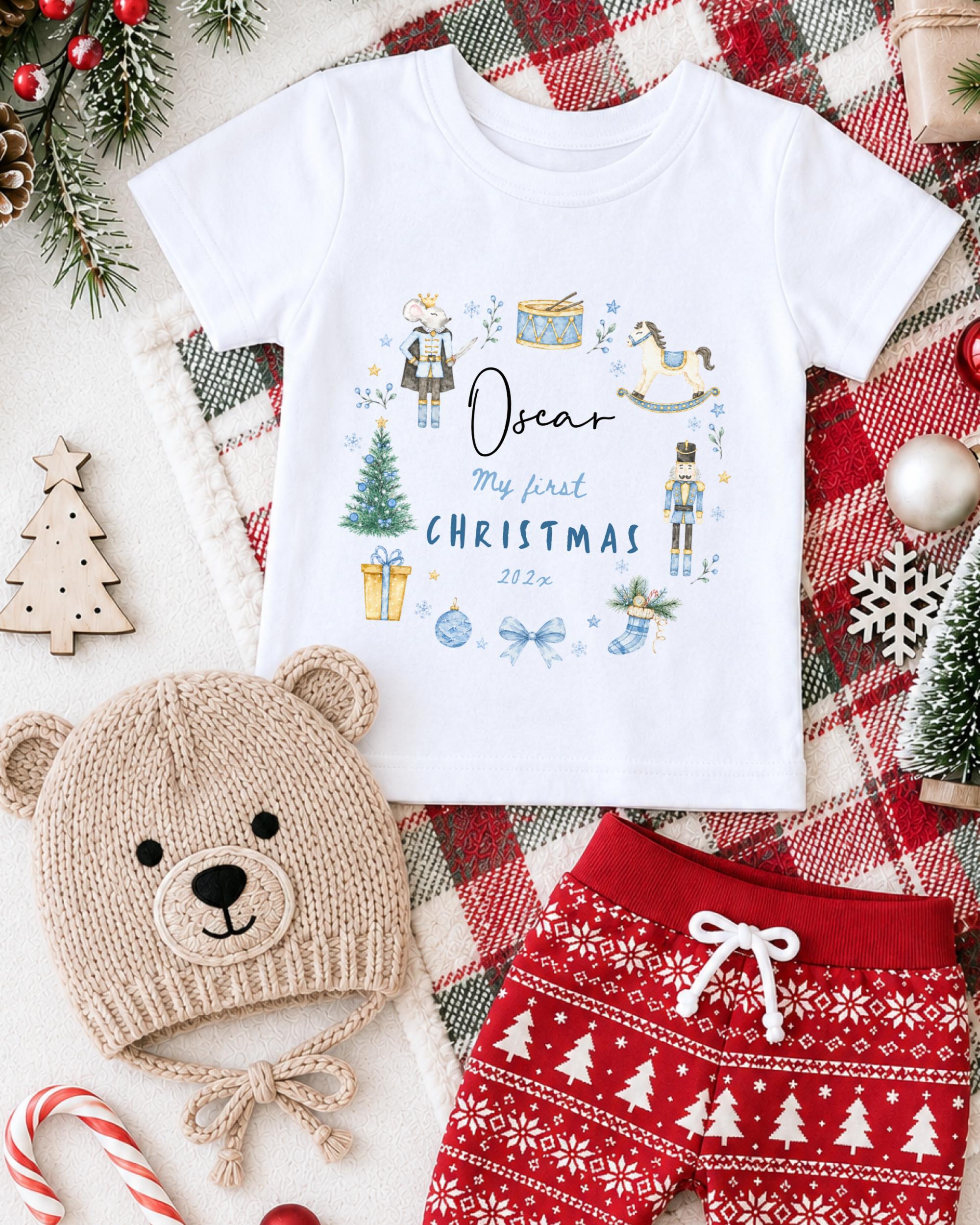 A white t-shirt with a Christmas-themed design, a knitted hat, a pair of red shorts, and various Christmas decorations such as a Christmas tree, ornaments, and a snowflake.