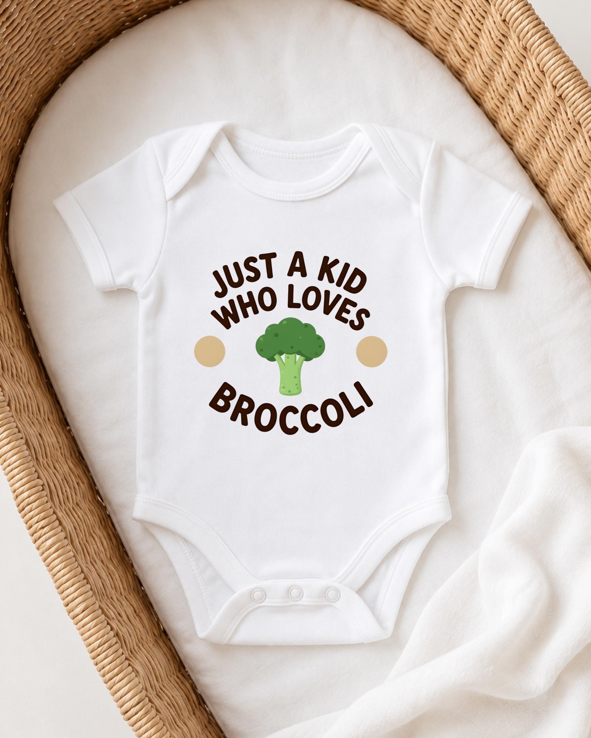 A white onesie with the text "JUST A KID WHO LOVES BROCCOLI" printed on it, along with a broccoli graphic.