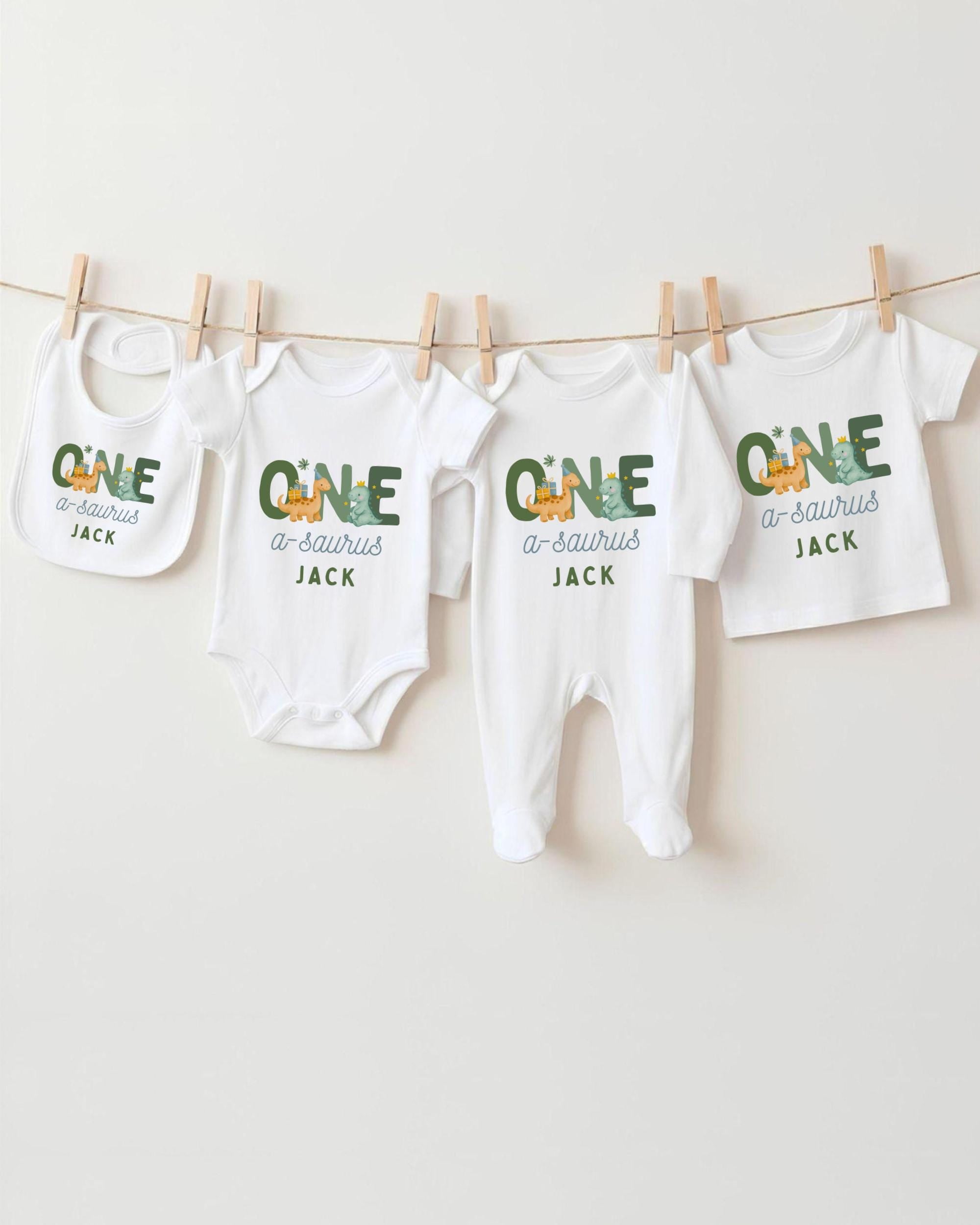 A row of white baby clothes with the name "Jack" printed on them, hanging on a clothesline.