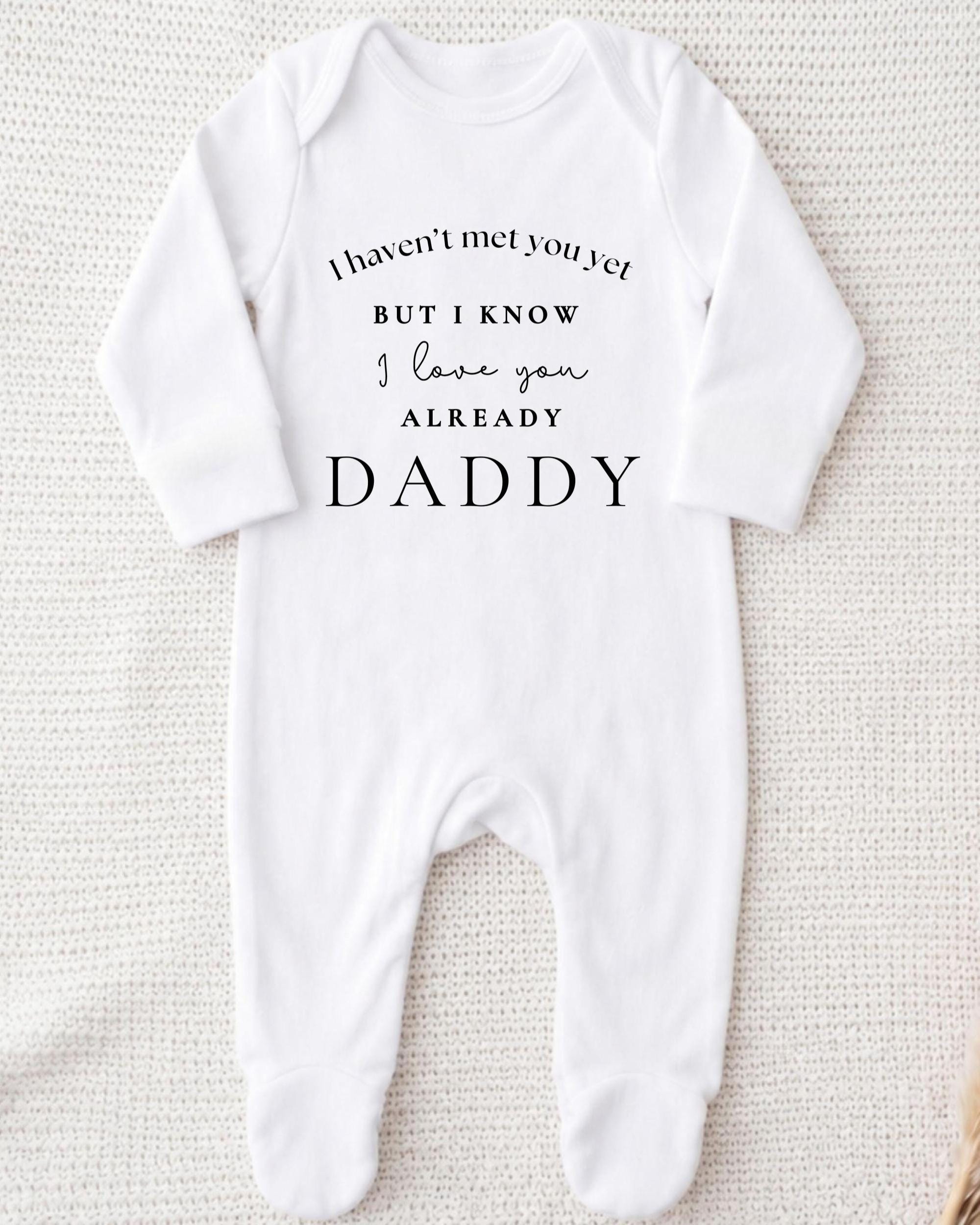A white onesie with text printed on it.
