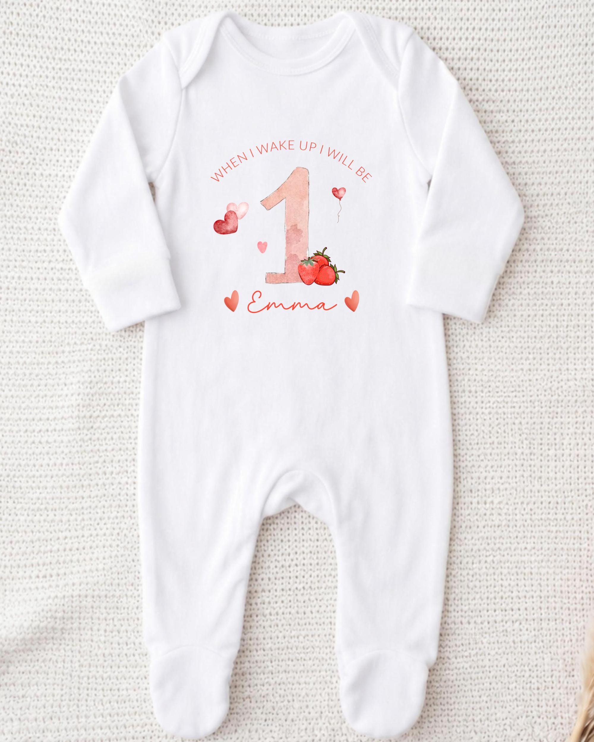 A white onesie with a personalized design for a baby girl.