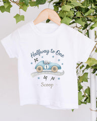 A white t-shirt with a graphic design of a race car and the text "Halfway to One Scoop" printed on it.