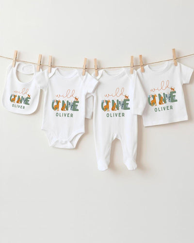 A collection of baby clothes and bibs hanging on a clothesline, with the clothes featuring the name "OLIVER" printed on them.