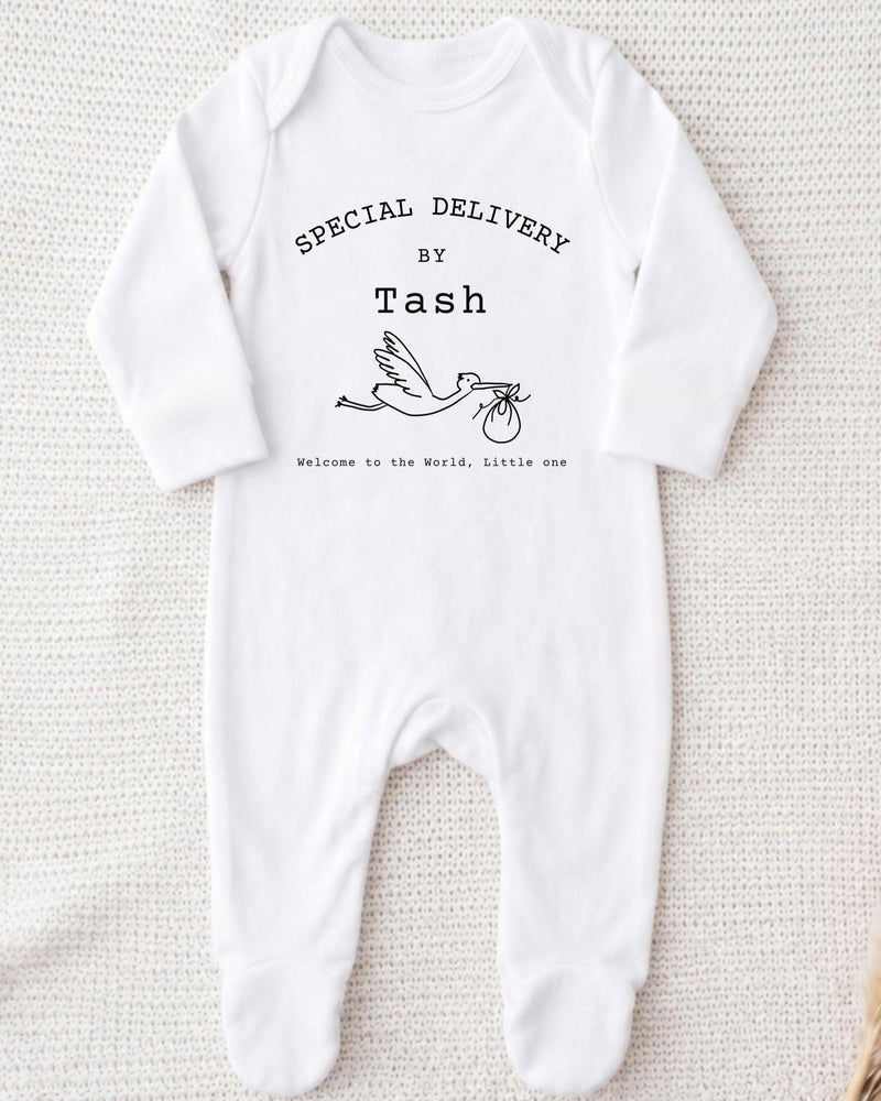 A white bodysuit with text and a graphic of a baby swan.