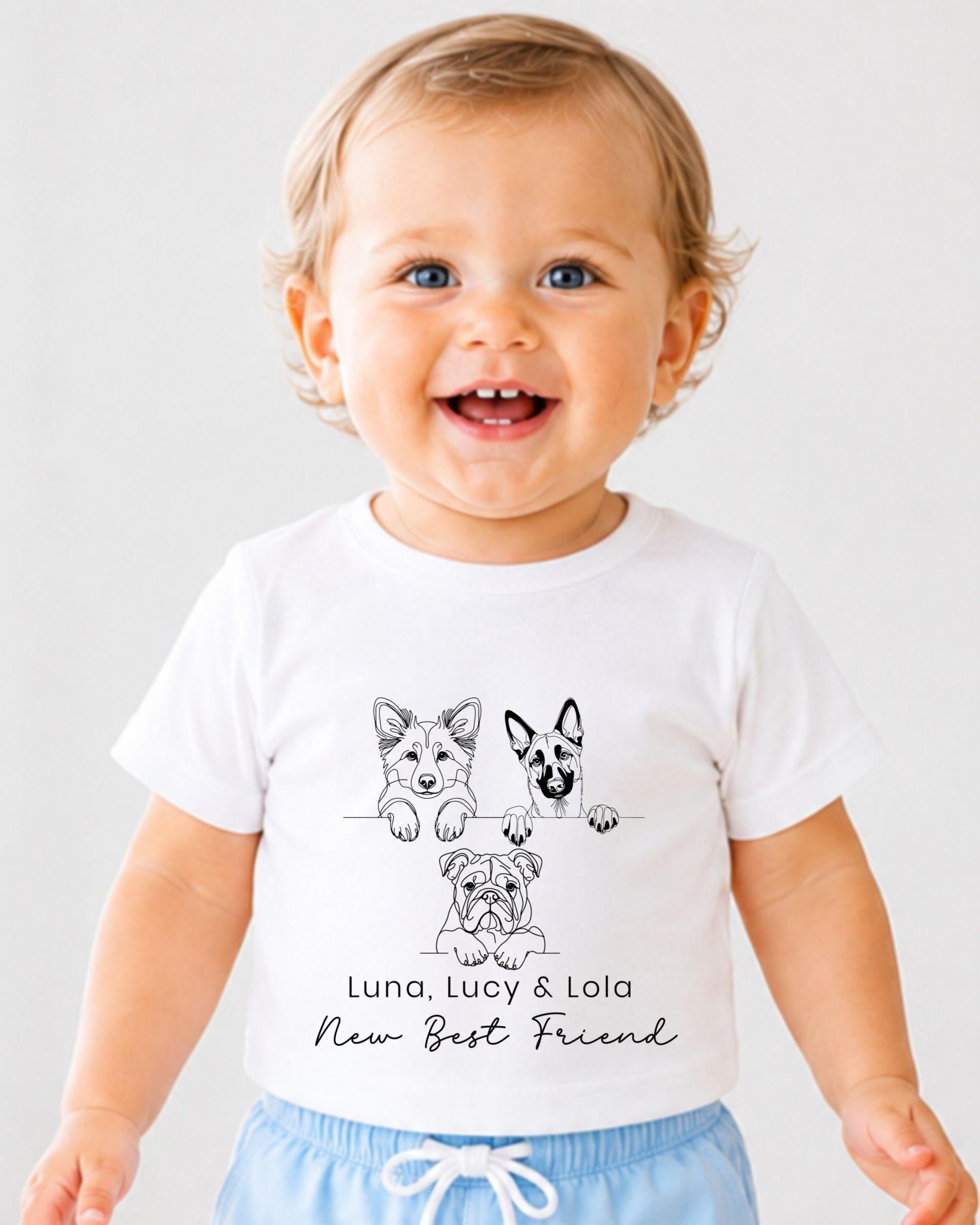 A smiling baby wearing a white t-shirt with a graphic of three dogs and the text "Luna, Lucy & Lola - New Best Friend" printed on it.