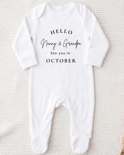 Personalisable white Baby Grow with black 'Hello Nanny & Grandpa See you in October' serif and script lettering.