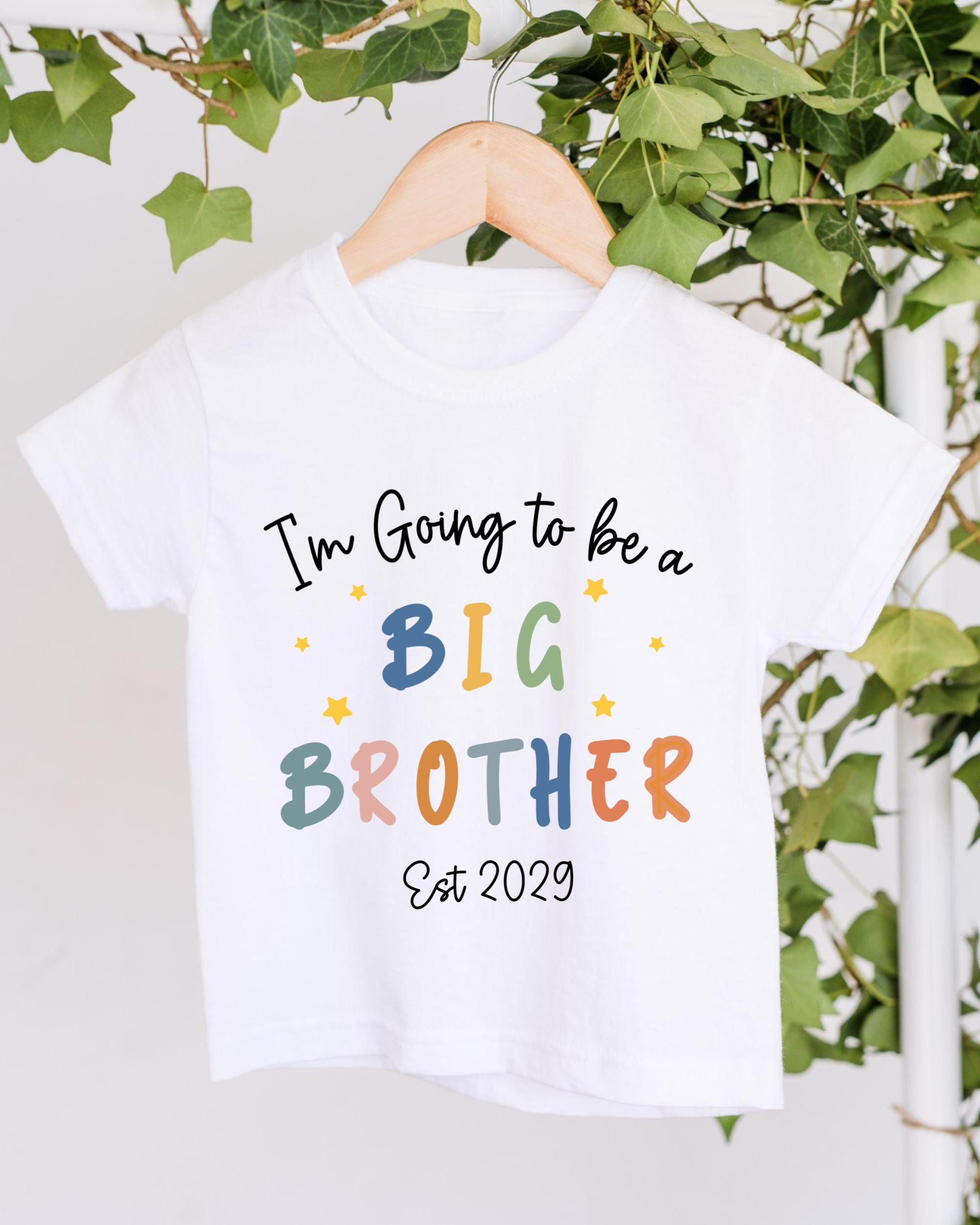 A white t-shirt with text that says "I'm Going to be a BIG BROTHER" and "Est 2029" printed on it.