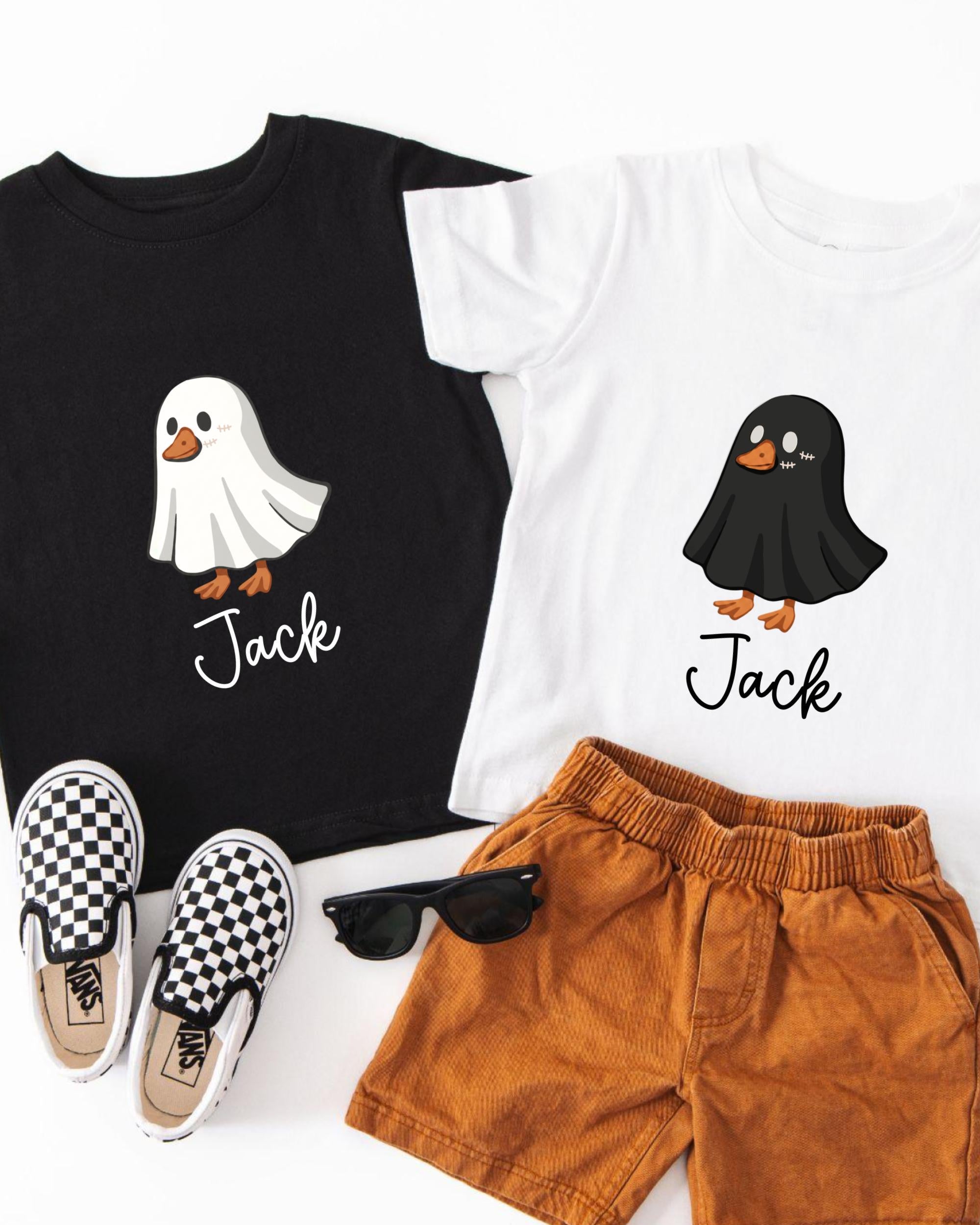 A black t-shirt with a ghost character, a white t-shirt with a black ghost character, a pair of brown shorts, and a pair of black and white checkered shoes.