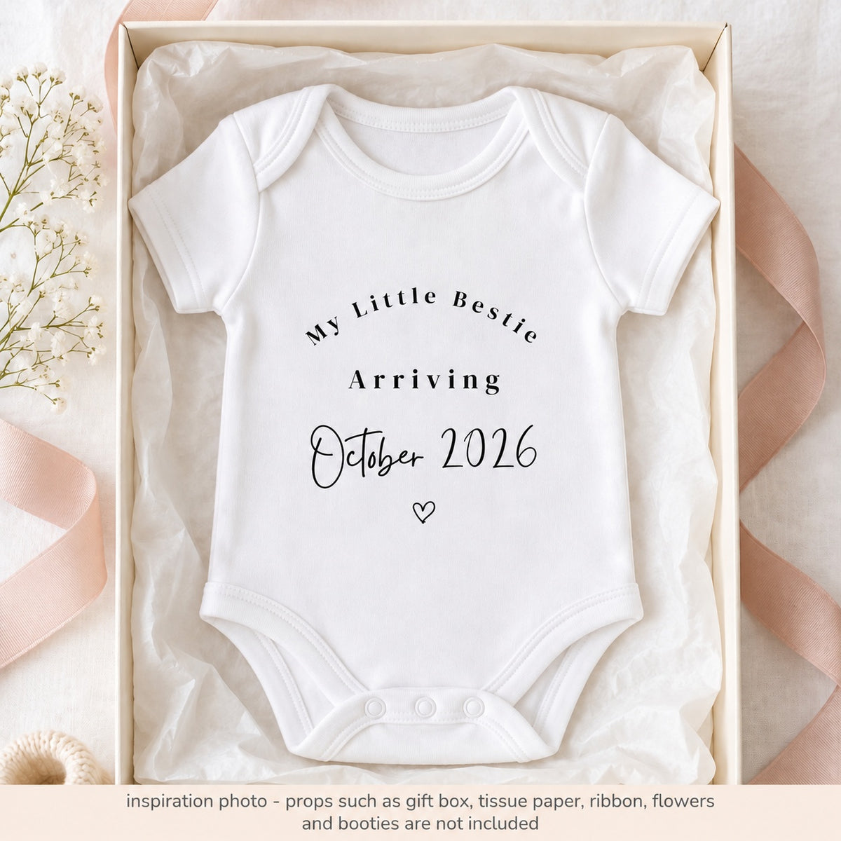 White My Little Bestie pregnancy announcement baby vest with October 2026 print in a tissue-lined ivory gift box with blush ribbon.
